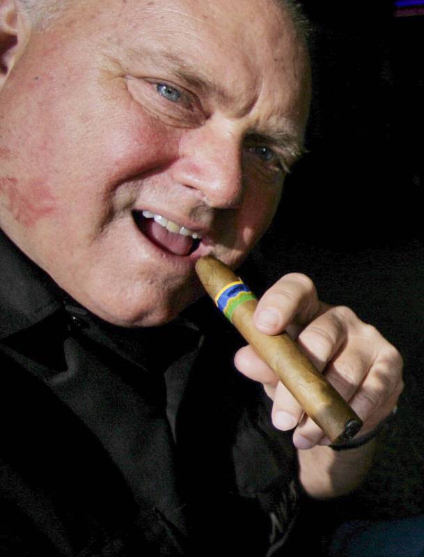 In this April 7, 2005 file photo, Moonlite BunnyRanch owner Dennis Hof smokes a cigar at his br ...