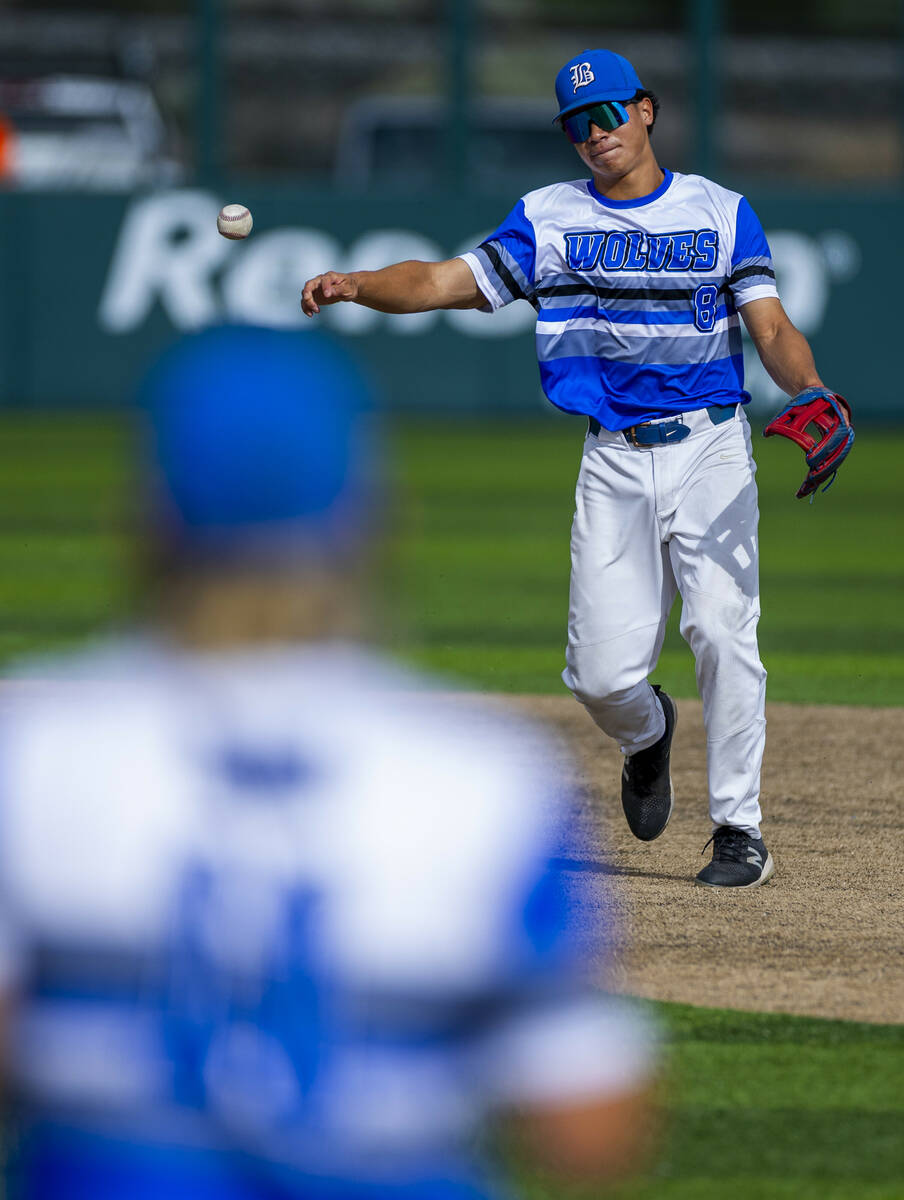 Basic infielder Tate Southisene (8) tosses the ball too first base against Reno during day one ...