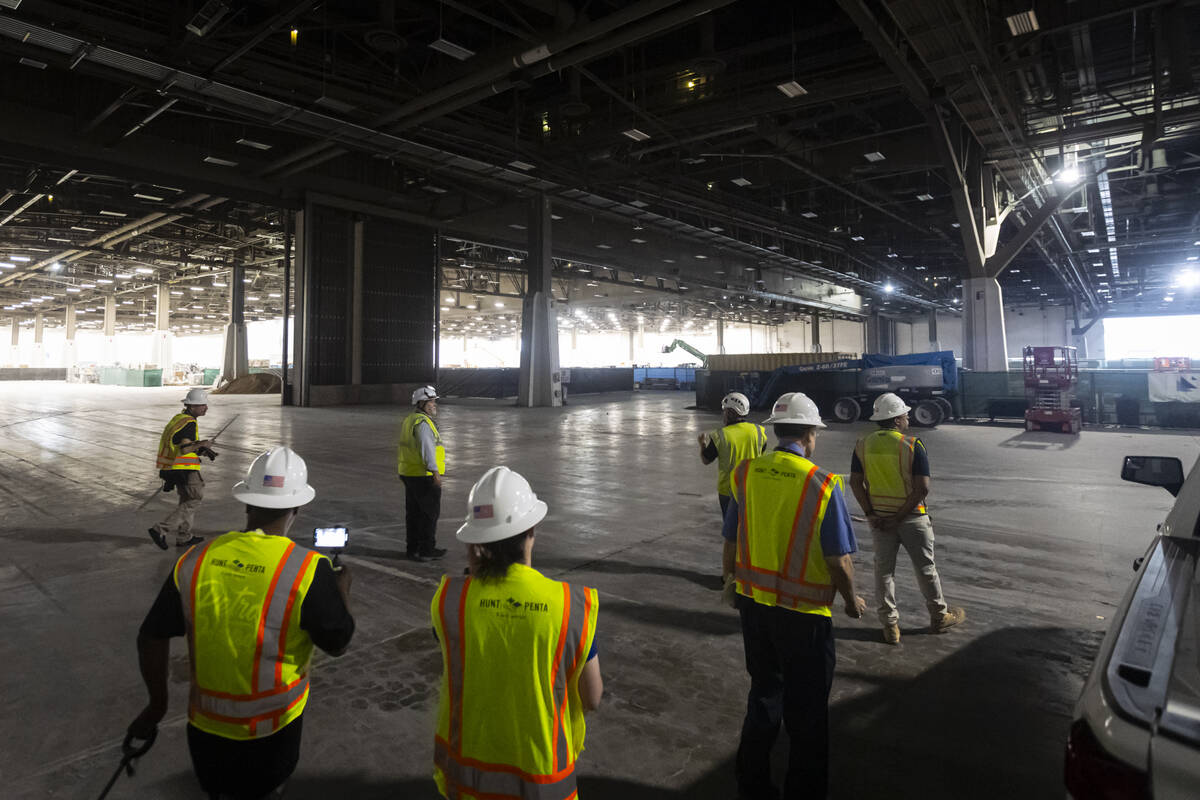 Members of the media walk through the central hall as renovation progress continues at the Las ...