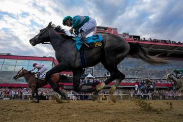 Umberto Rispoli, left, atop Journalism, edges out Luis Saez, atop Gosger, to win the 150th runn ...