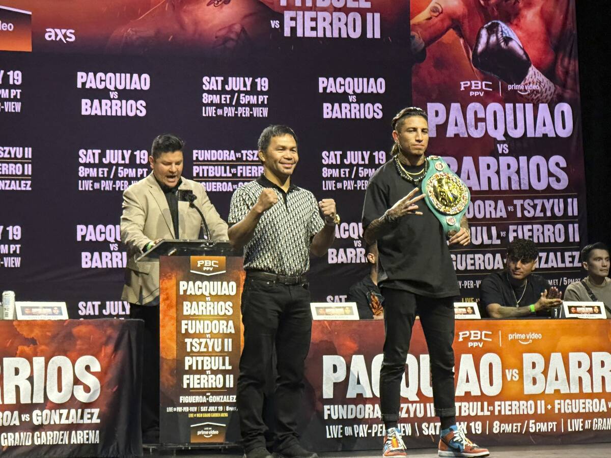 Manny Pacquiao, center, and WBC welterweight champion Mario Barrios pose at a news conference i ...