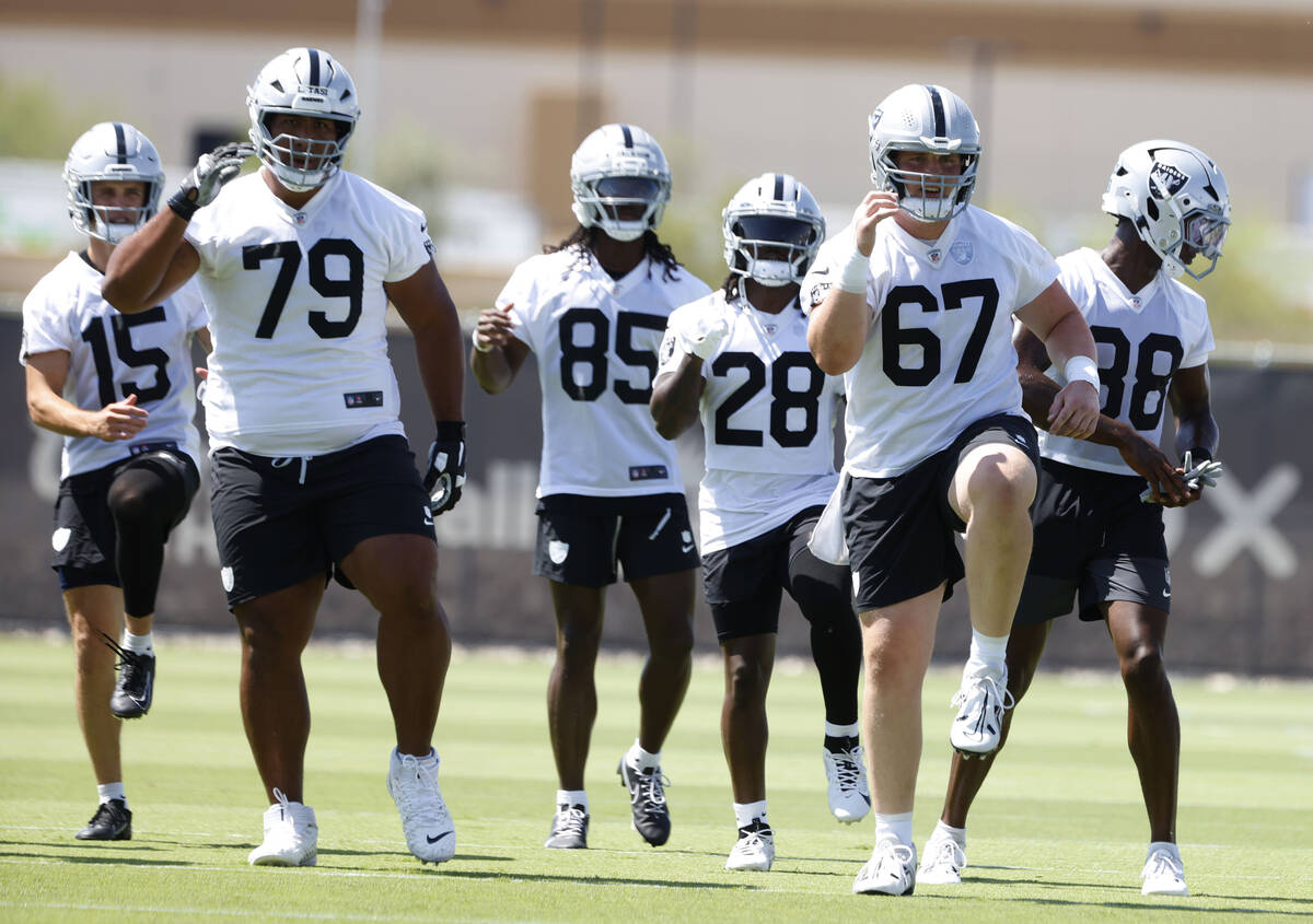 Raiders players warm up during team's practice at the Intermountain Health Performance Center o ...