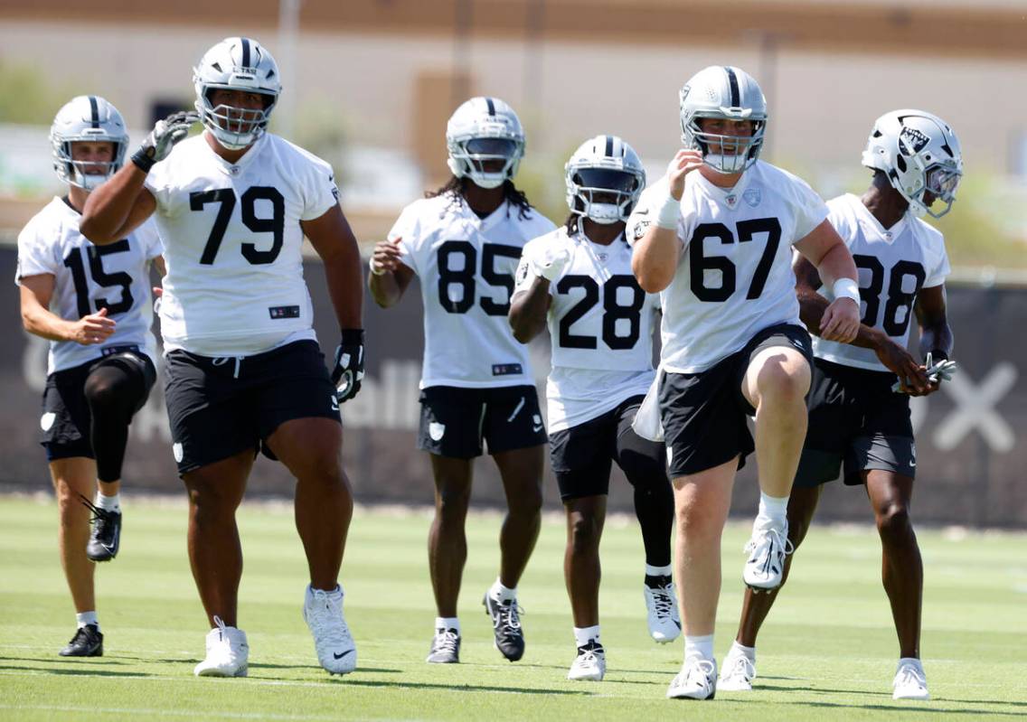Raiders players warm up during organized team activities at the Intermountain Health Performanc ...