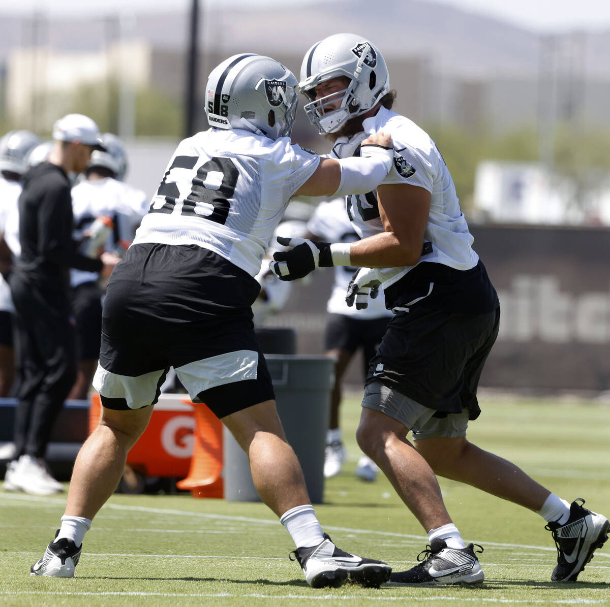 Raiders guard Jackson Powers-Johnson (58) blocks offensive tackle Dalton Wagner (78) during tea ...