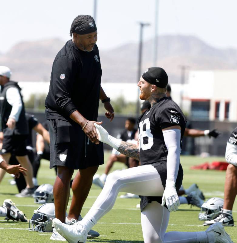 Raiders defensive coordinator Patrick Graham greets defensive end Maxx Crosby (98) during organ ...