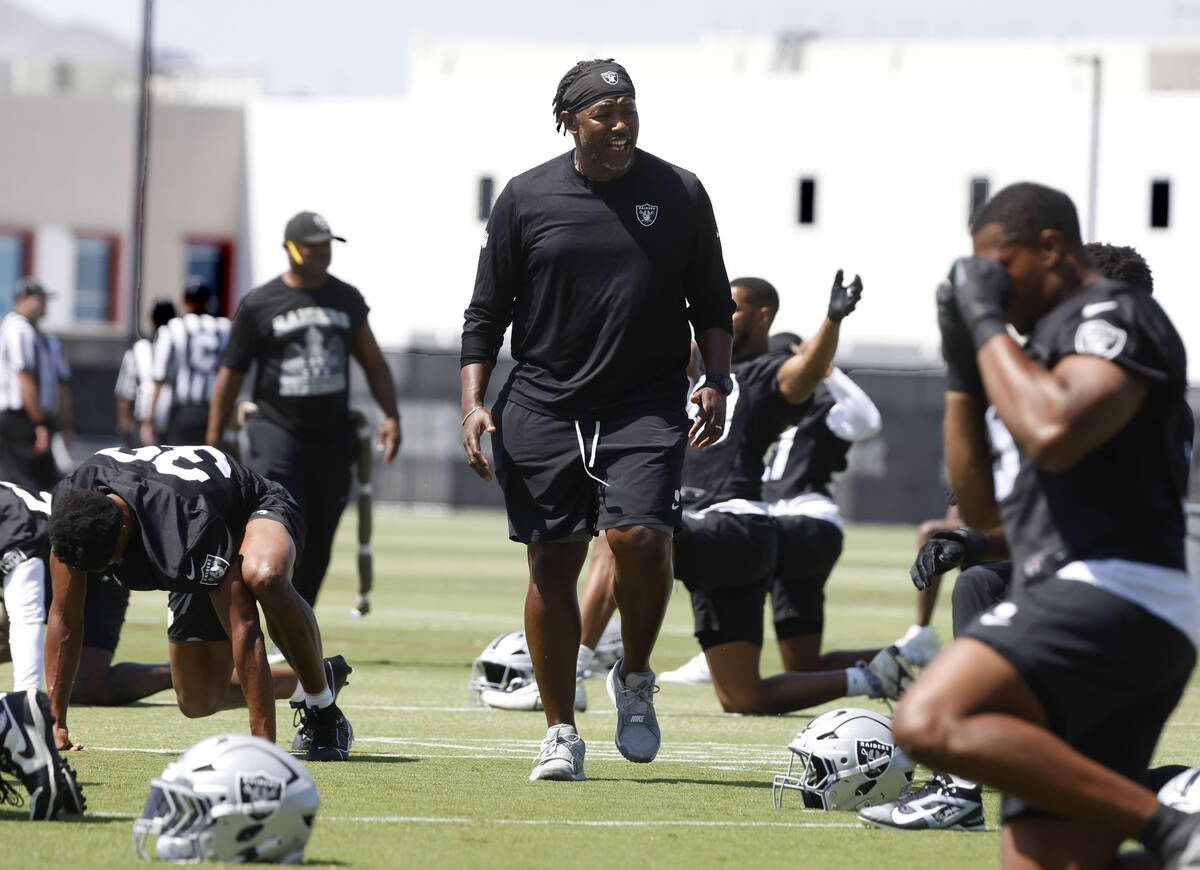 Raiders defensive coordinator Patrick Graham watches as players stretch during team's practice ...