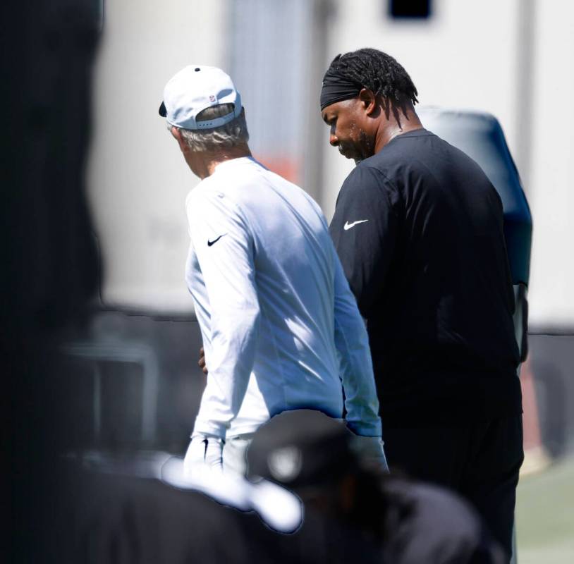 Raiders head coach Pete Carroll, left, and defensive coordinator Patrick Graham discuss during ...