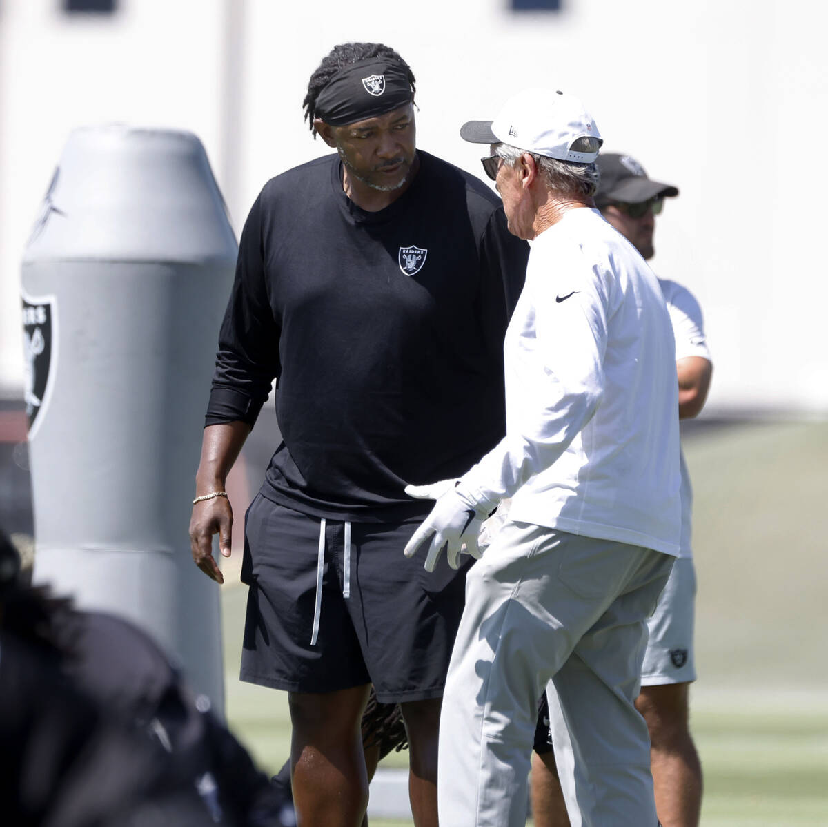 Raiders head coach Pete Carroll, right, and defensive coordinator Patrick Graham discuss during ...