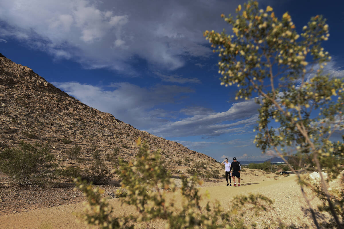 July Pabon and Armando Morelo hike a trail at Lone Mountain Regional Park Wednesday, June 4, 20 ...
