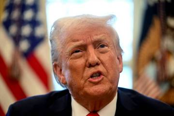 President Donald Trump speaks to the press after signing an executive order in the Oval Office ...