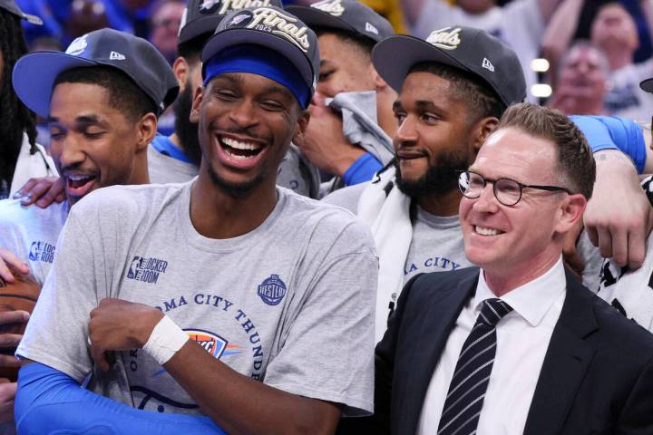 Oklahoma City Thunder guard Shai Gilgeous-Alexander, left, laughs next to general manager Sam P ...