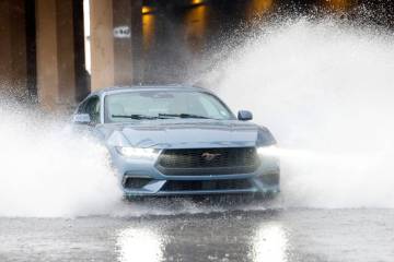 A vehicle makes a wake taller than itself while traveling down Martin Luther King Boulevard on ...