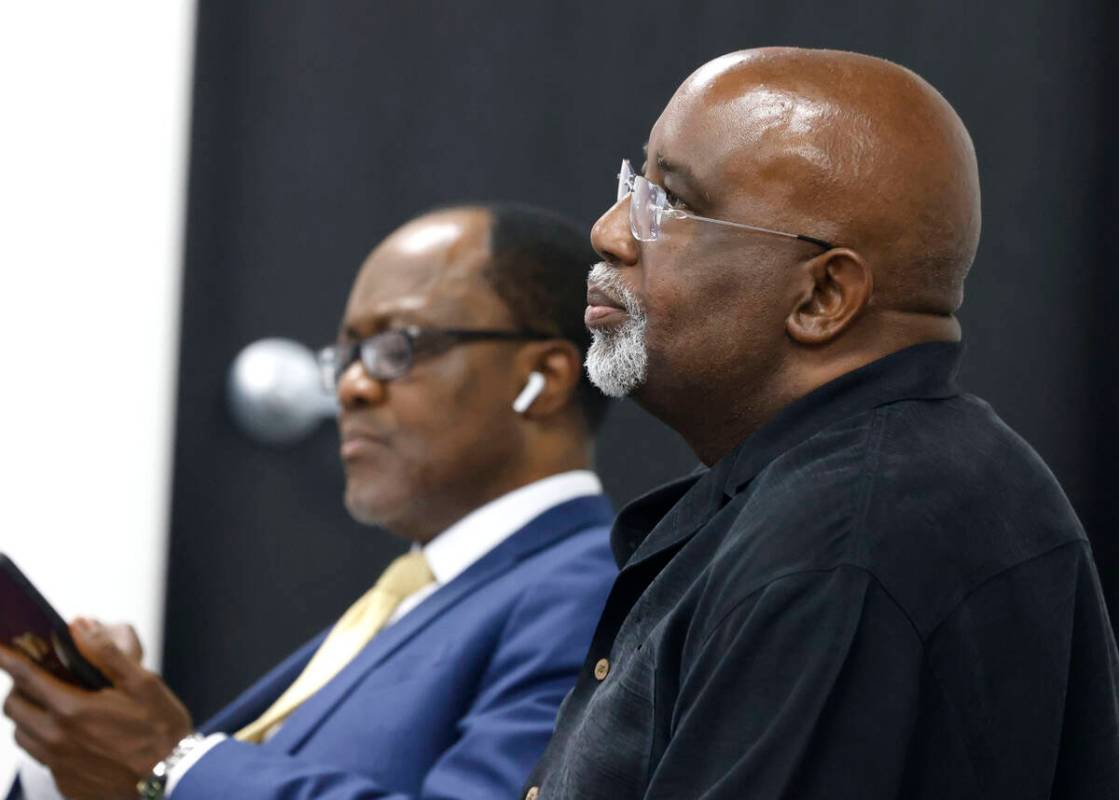 Dr. George Chambers, center, a local OB-GYN, waits for a hearing with his attorney Libo Agwara, ...