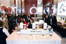 Attendees check out Pandora's jewelry after a ribbon-cutting ceremony for the store at BLVD on ...