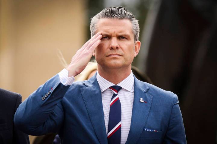 U.S. Defense Secretary Pete Hegseth salutes during a ceremony at the US cemetery to commemorate ...