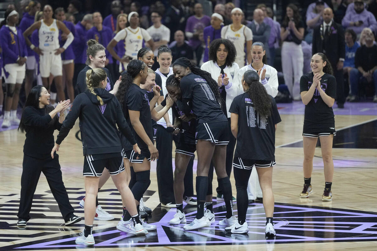 Golden State Valkyries head coach Natalie Nakase, left, and players gather before a WNBA basket ...