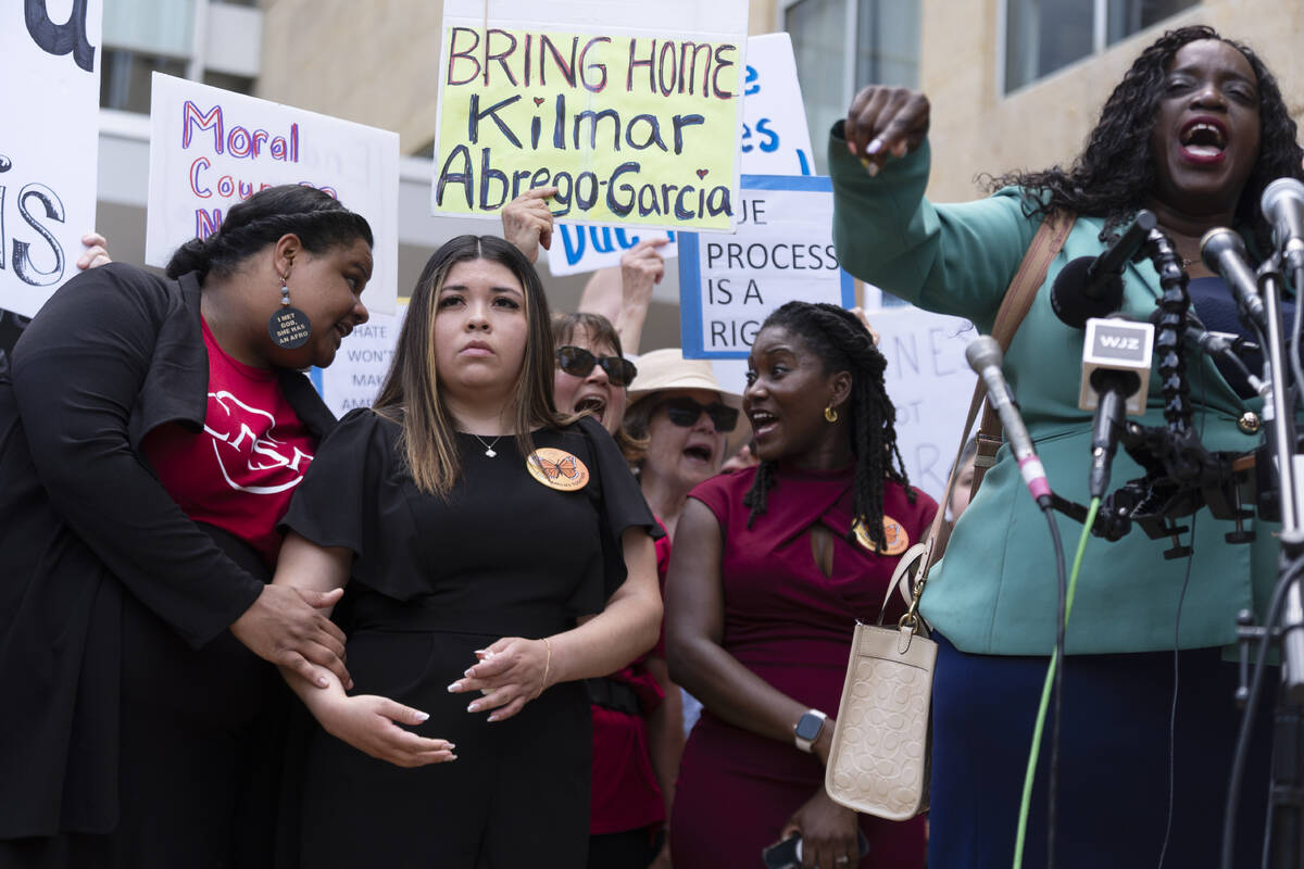 Wife of Kilmar Abrego Garcia, Jennifer Vasquez Sura, second from left, joins a rally outside th ...