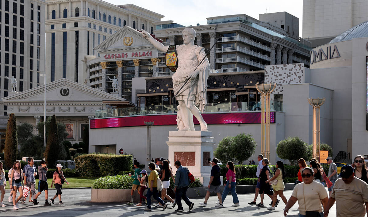 A World Wrestling Entertainment championship belt hangs from the Caesar statue in front of Caes ...