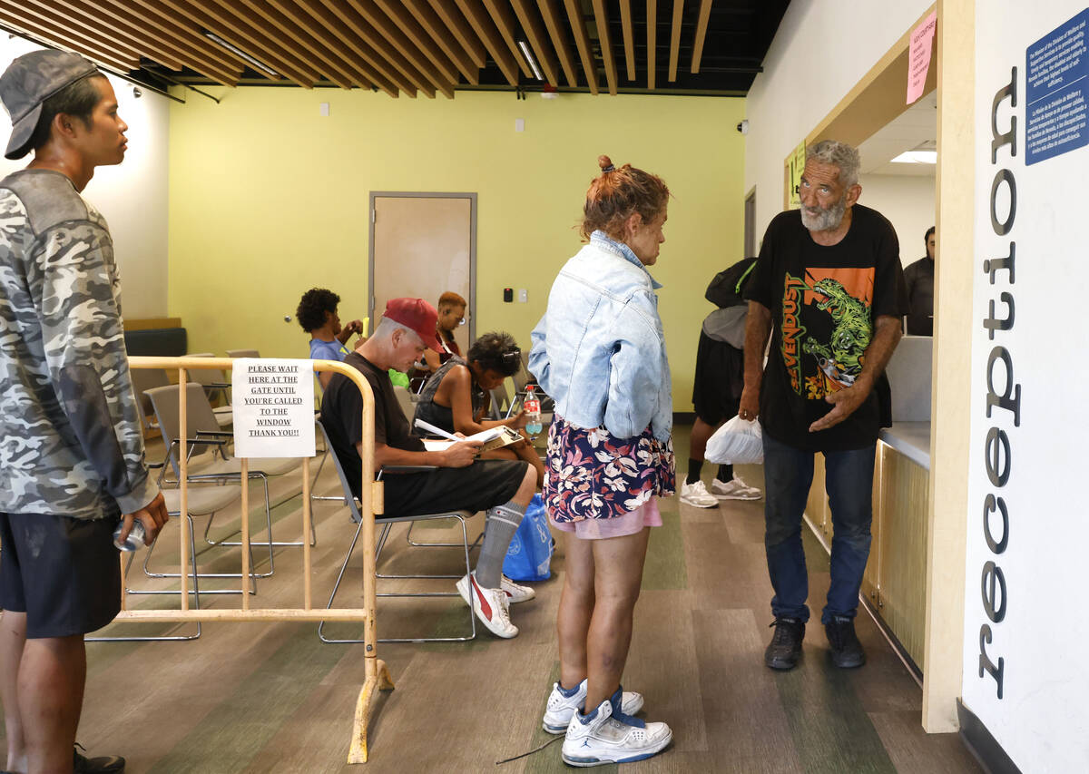 People line up to register and to stay indoor during a hot Monday afternoon at the Courtyard Ho ...