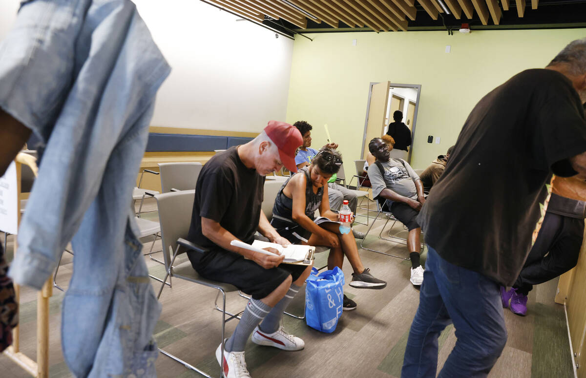 People line up to register and to stay indoor during a hot Monday afternoon at the Courtyard Ho ...