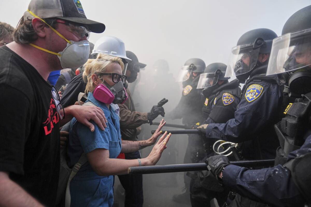 Protesters confront police on the 101 Freeway near the Metropolitan Detention Center of downtow ...