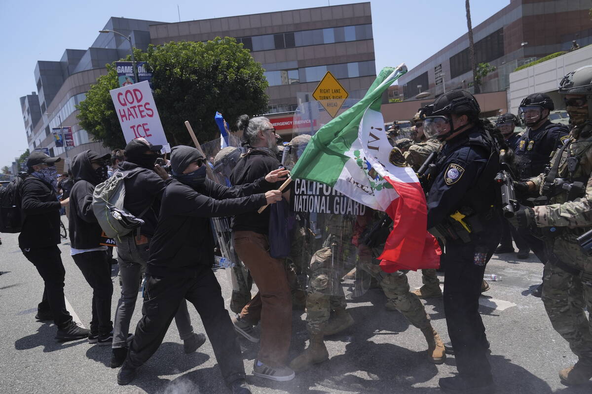 Protesters clash with authorities in downtown Los Angeles, Sunday, June 8, 2025, following last ...