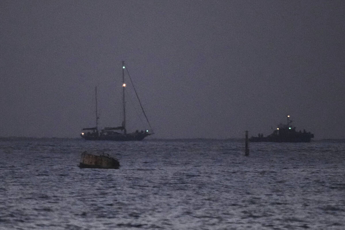 The Gaza-bound aid boat, Madleen, left, under escort of Israeli naval forces making its way tow ...