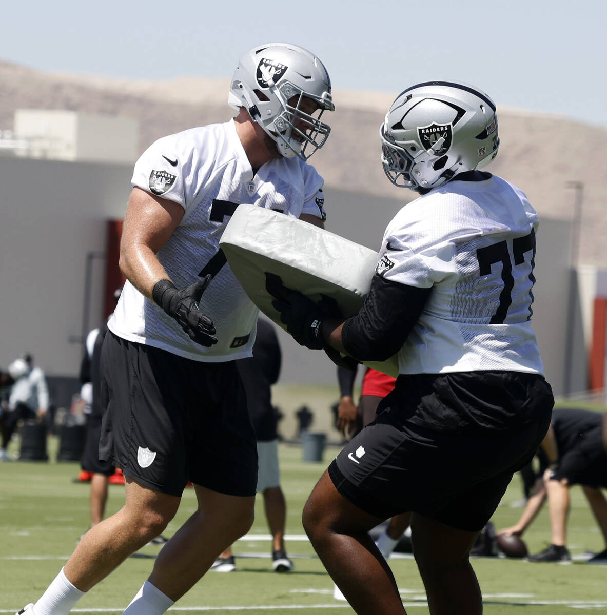 Raiders offensive tackles Kolton Miller (74) and Thayer Munford Jr. (77) work on drills during ...