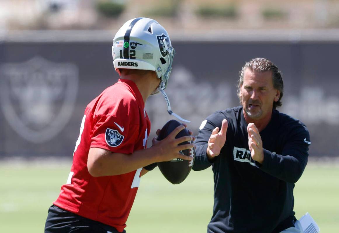 Raiders quarterback Aiden O'Connell (12) works with quarterback coach Greg Olson during an NFL ...