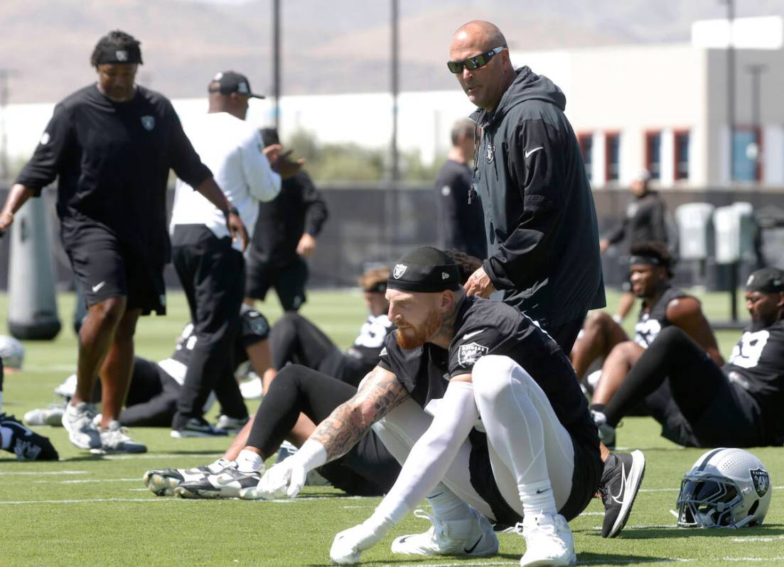 Raiders special teams coordinator Tom McMahon walls past defensive end Maxx Crosby (98) during ...