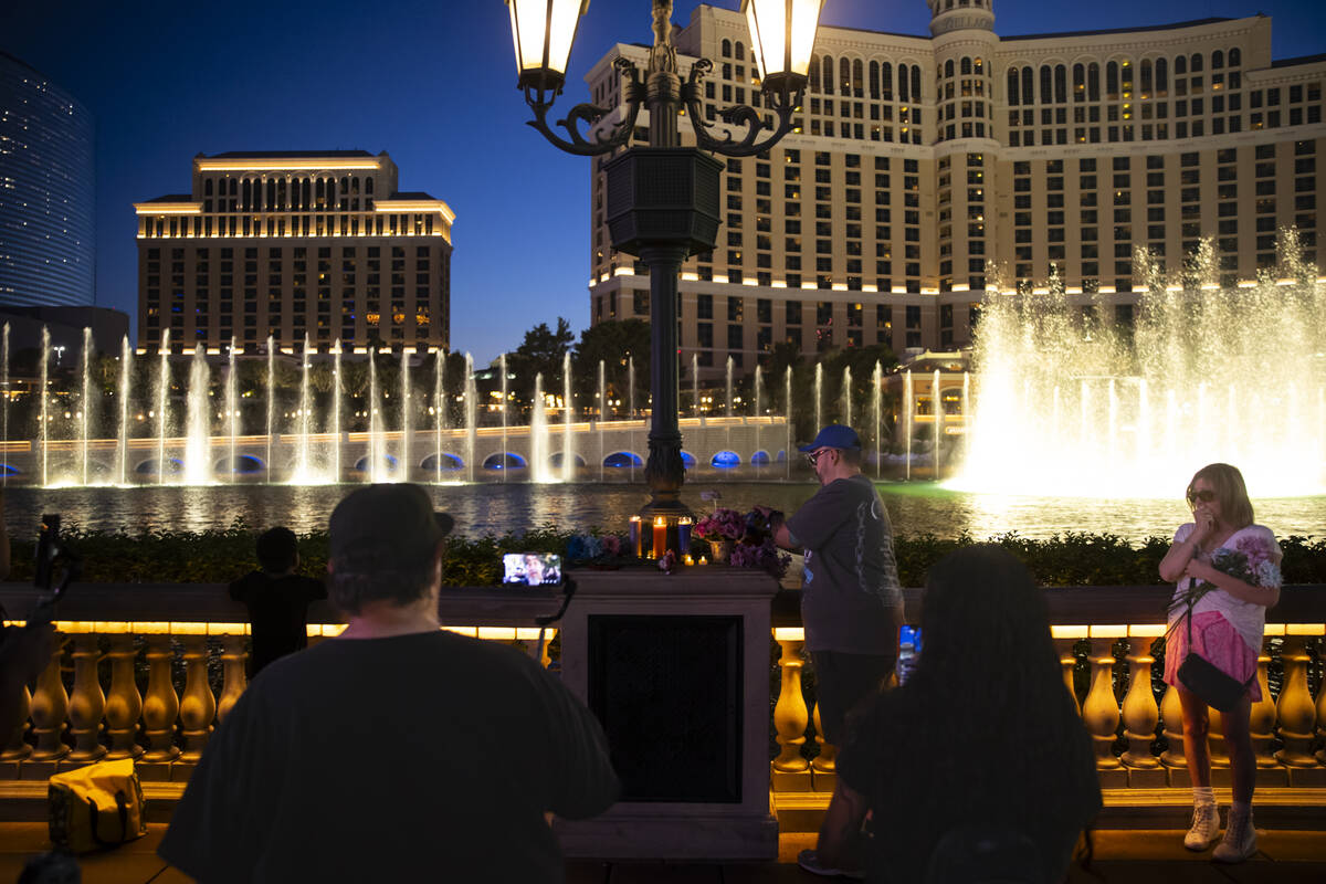 People gather by the Bellagio Fountains for a vigil in memory of Rodney Finley, a YouTube strea ...