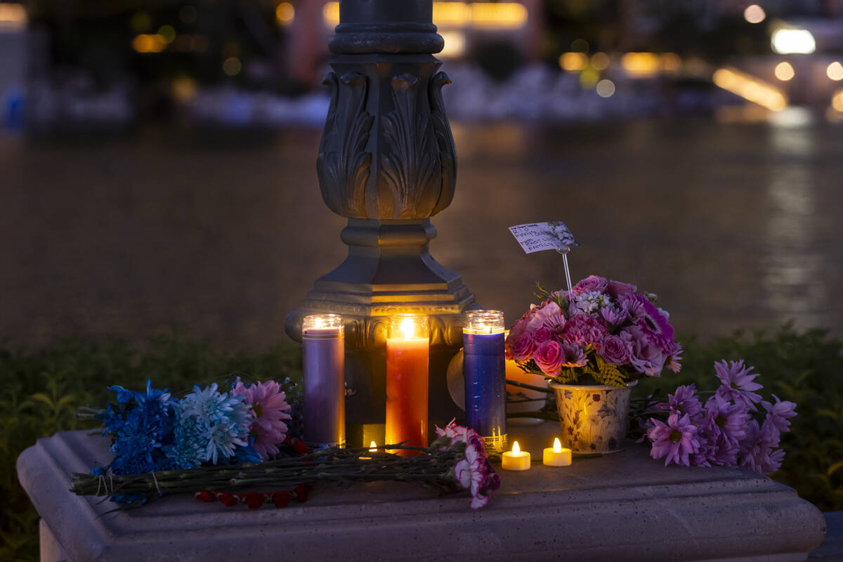 Candles and flowers are seen by the Bellagio Fountains for a vigil in memory of Rodney Finley, ...