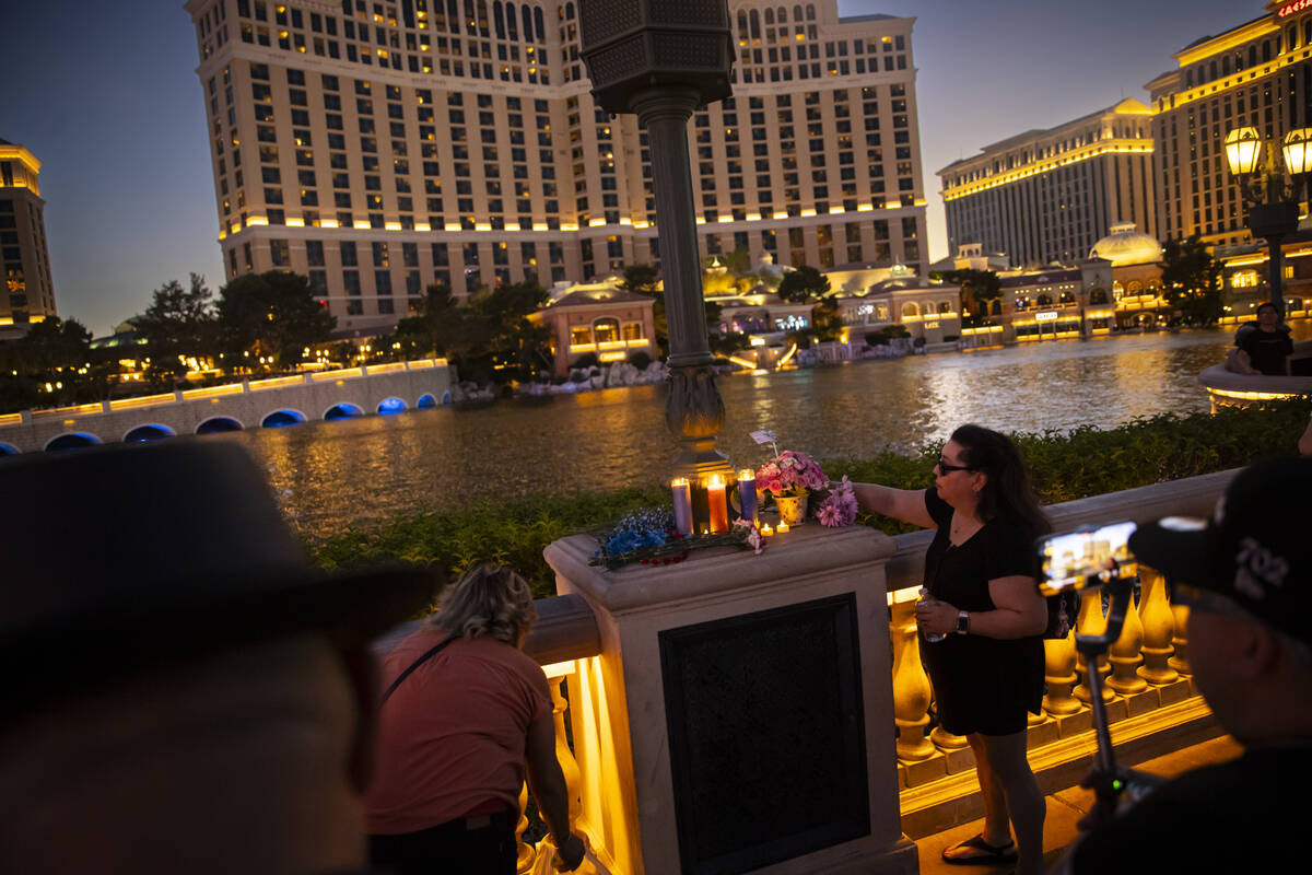 Dolores, a TikTok streamer who declined to give her last name, places flowers by the Bellagio F ...