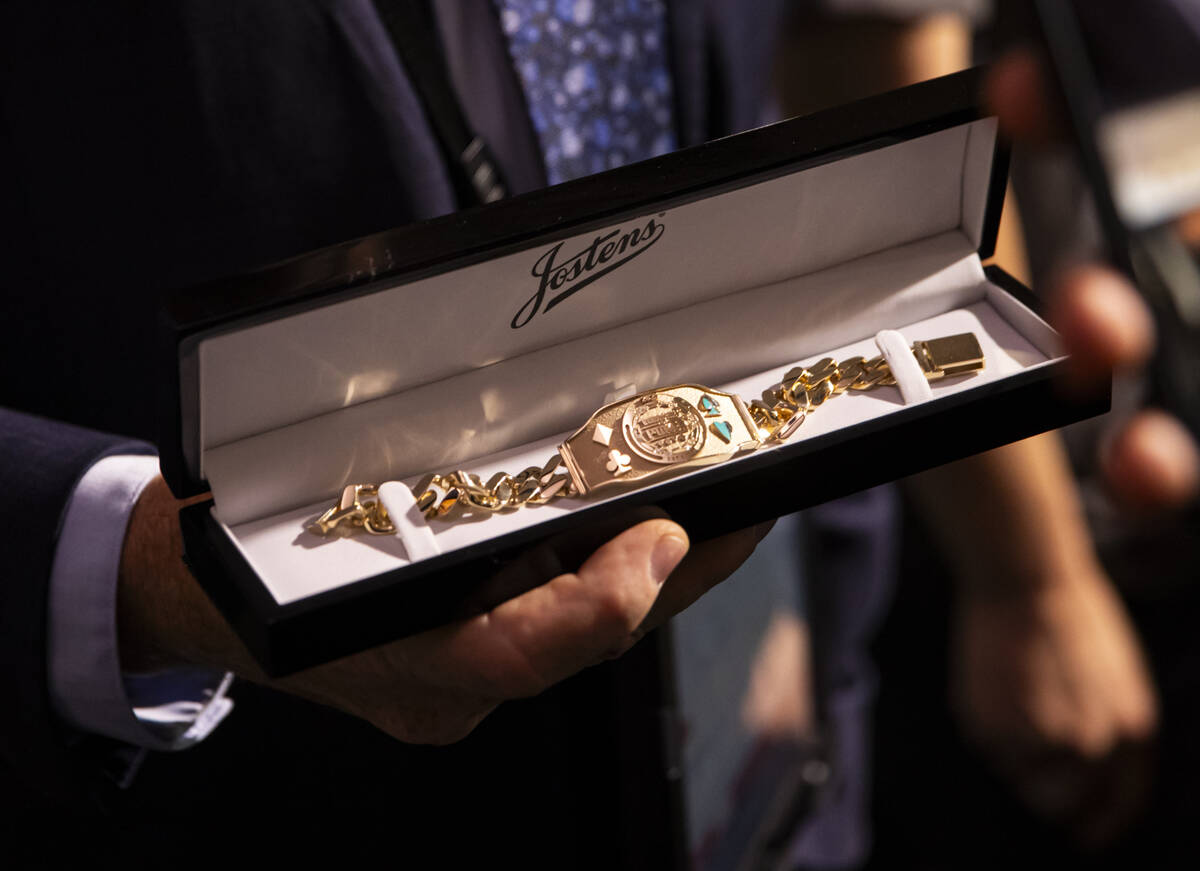 World Series of Poker tournament shift manager Bob Smith shows off the winner’s bracelet ...