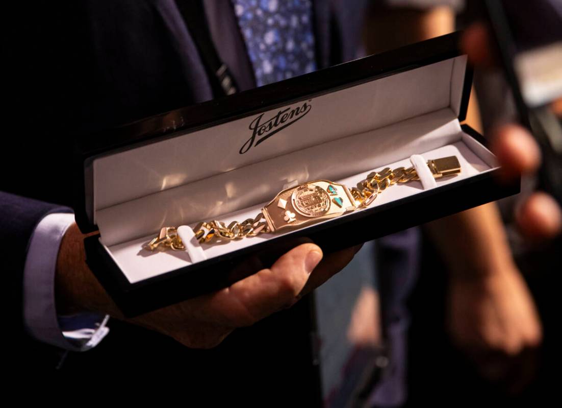 World Series of Poker tournament shift manager Bob Smith shows off the winner’s bracelet ...