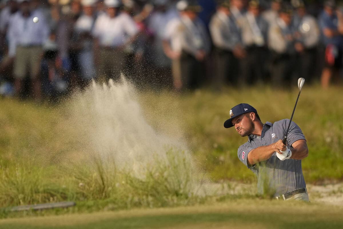 Bryson DeChambeau hits from the bunker on the 18th hole during the final round of the U.S. Open ...