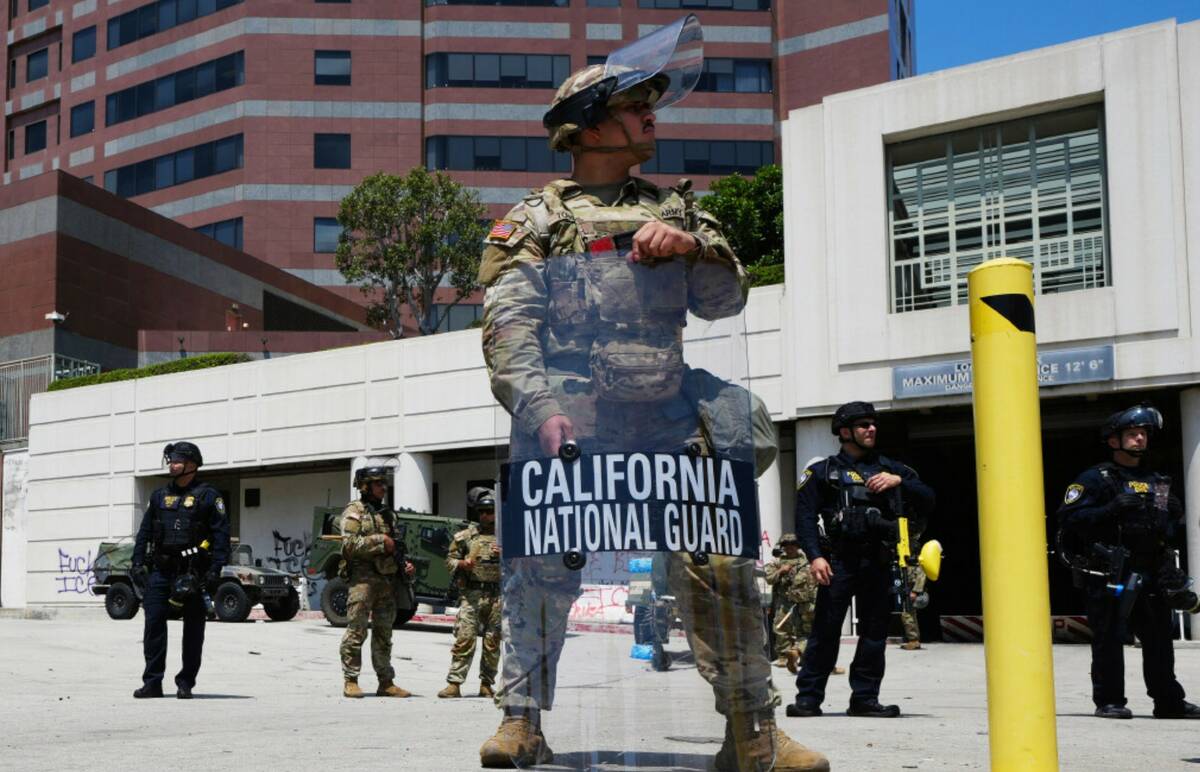 U.S. National Guard stand protect buildings Tuesday, June 10, 2025, in Los Angeles. (AP Photo D ...