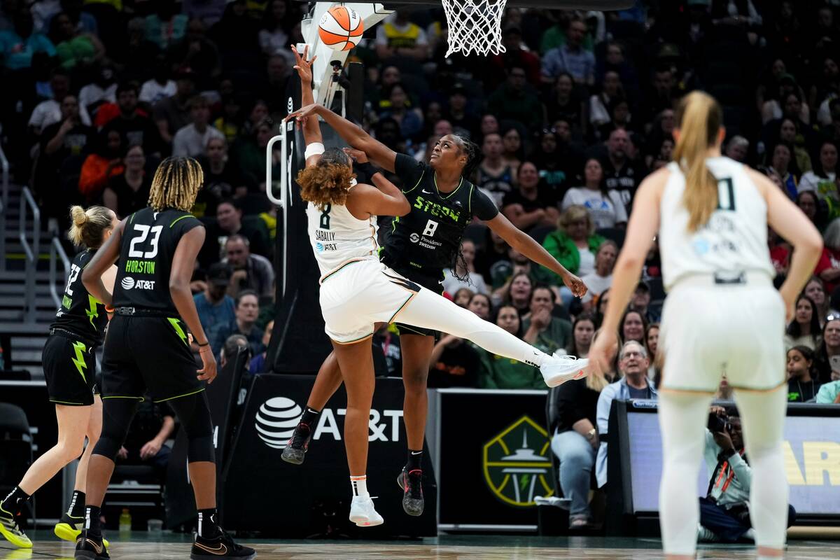 Seattle Storm forward Joyner Holmes (8) swats the ball away from New York Liberty forward Nyara ...