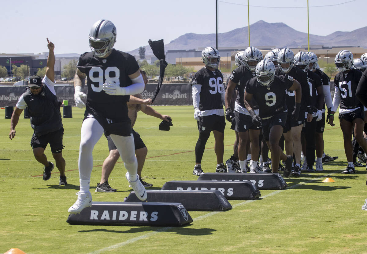 Raiders defensive end Maxx Crosby (98) leads the team during a drill as Raiders defensive end T ...