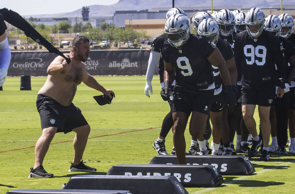 Assistant coach Rip Rowan rallies the defensive players during a drill led by Raiders defensive ...