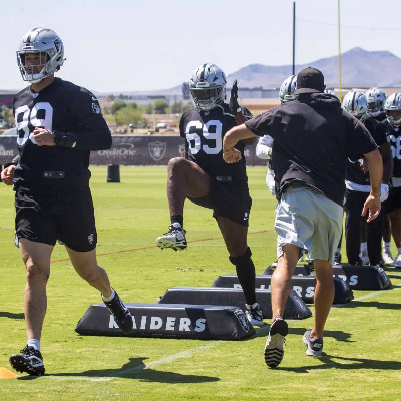 Raiders defensive tackle Adam Butler (69) high-steps through a drill during an NFL football man ...