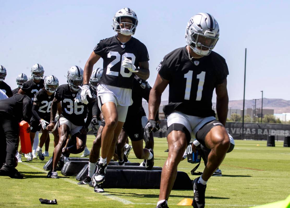 Raiders safety Isaiah Pola-Mao (20) and Raiders safety Jeremy Chinn (11) go through a drill dur ...