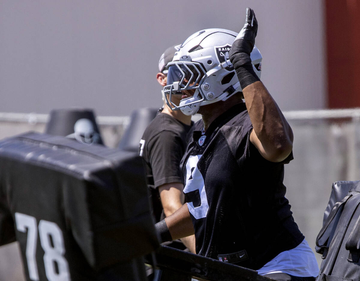 Raiders defensive end Tyree Wilson (9) goes through a tackle drill as defensive line coach Rob ...