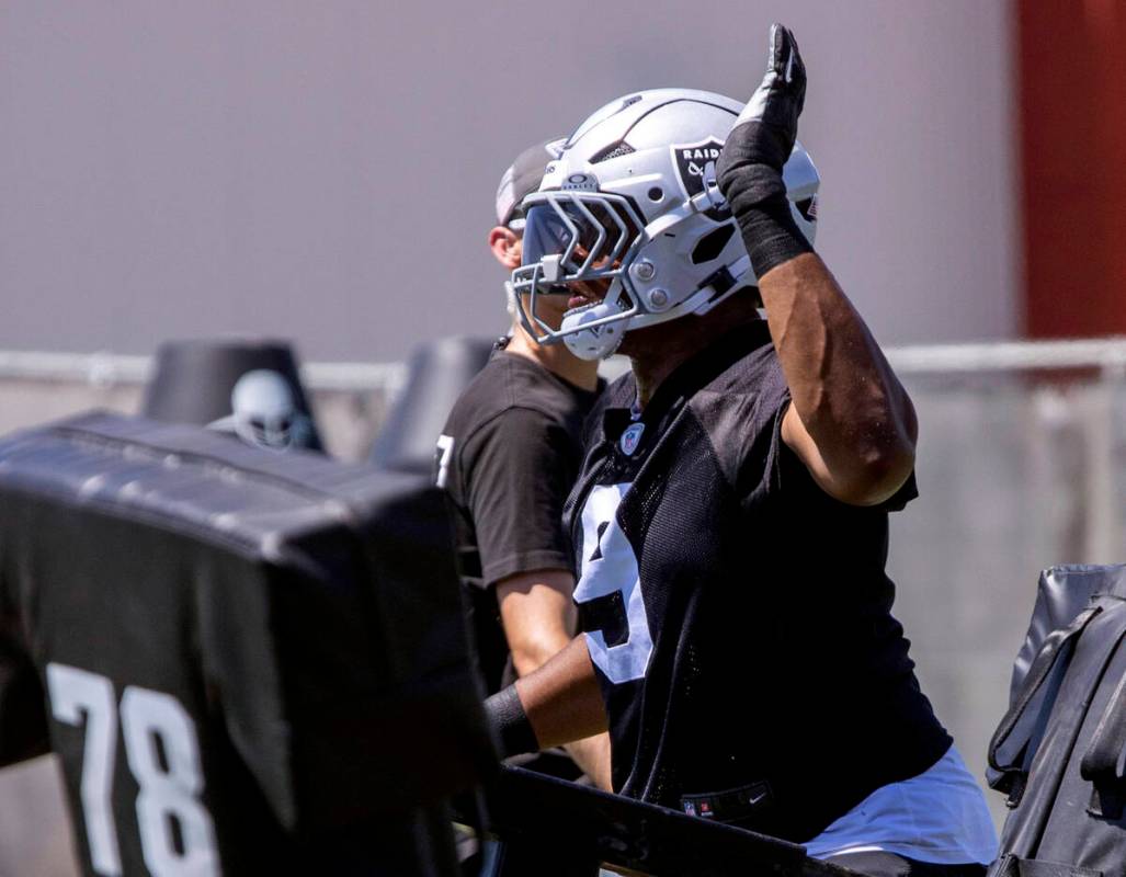 Raiders defensive end Tyree Wilson (9) goes through a tackle drill as defensive line coach Rob ...