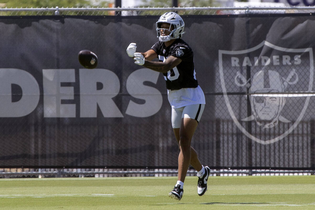 Raiders safety Isaiah Pola-Mao (20) pitches a football back to his teammates during an NFL foot ...