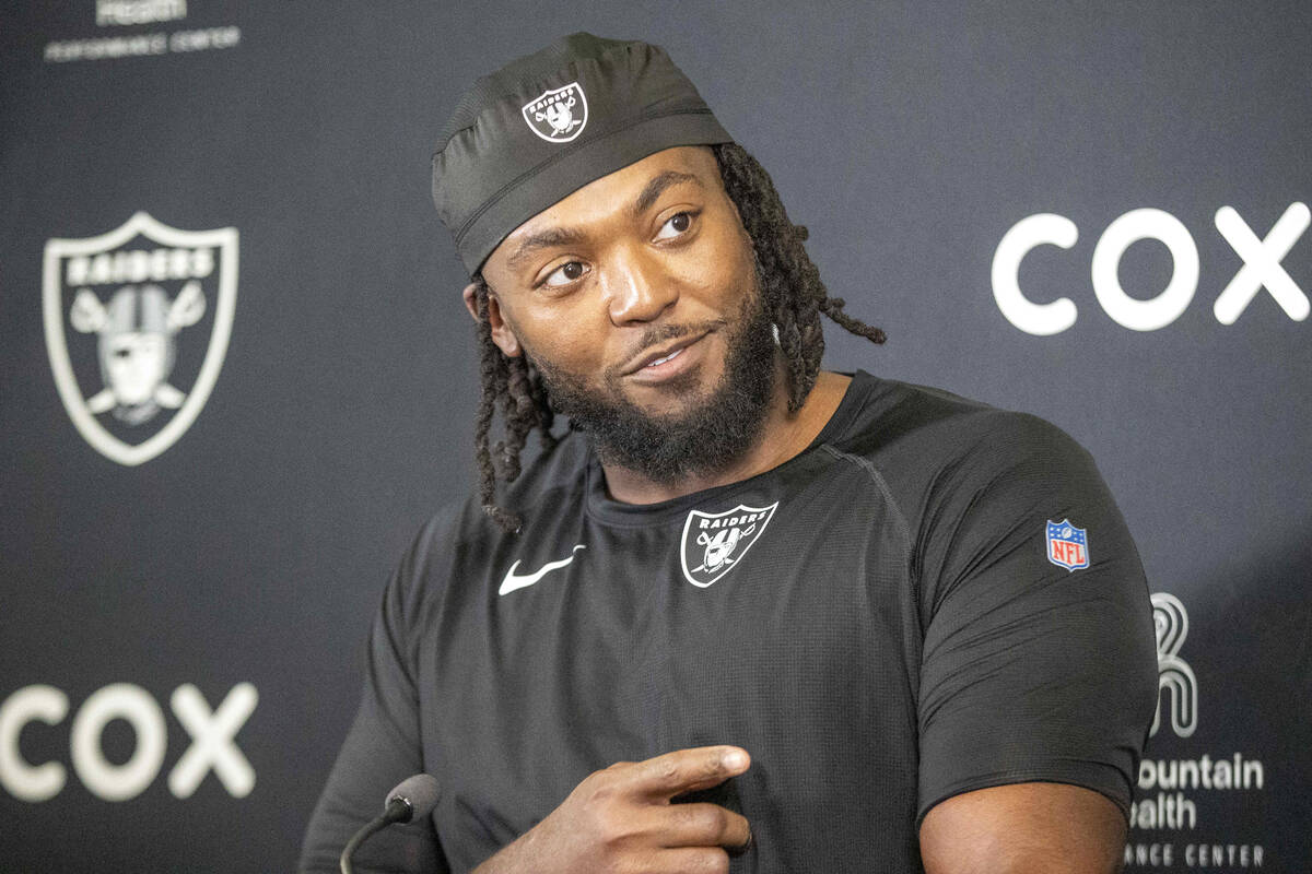 Raiders defensive tackle Adam Butler points to the media during a news conference following an ...