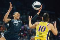 Aces center A'ja Wilson (22) keeps the ball in her possession as Los Angeles Sparks guard Kelse ...