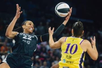 Aces center A'ja Wilson (22) keeps the ball in her possession as Los Angeles Sparks guard Kelse ...