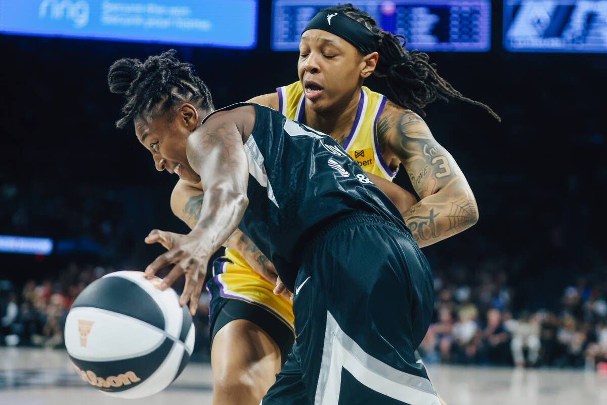 Aces guard Jewell Loyd (24) dribbles the ball past Los Angeles Sparks forward Emma Cannon (32) ...