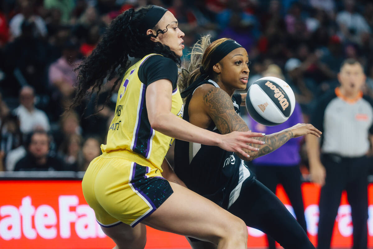 Aces guard Tiffany Mitchell (3) dribbles the ball as Los Angeles Sparks forward Dearica Hamby ( ...